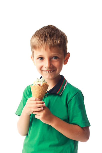 istock Little boy eating ice cream isolated on white 514830779