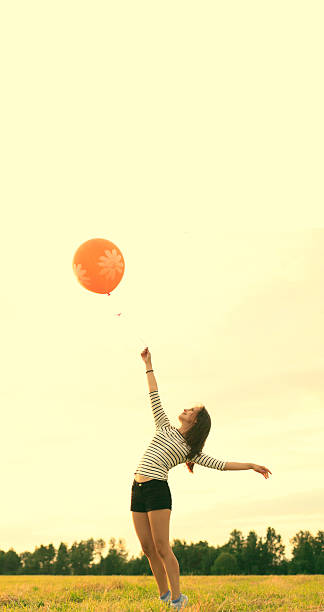 istock Happy woman with balloons 514831271
