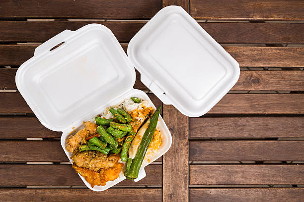 Convenient but unhealthy polystyrene lunch boxes with take away Convenient but unhealthy polystyrene lunch boxes with take away meal on wooden table polystyrene box stock pictures, royalty-free photos & images