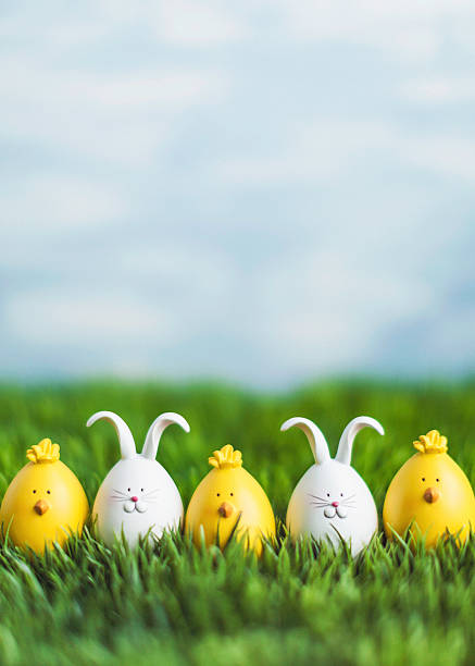 istock Little Easter critters sitting in grass with big blue sky 514837264