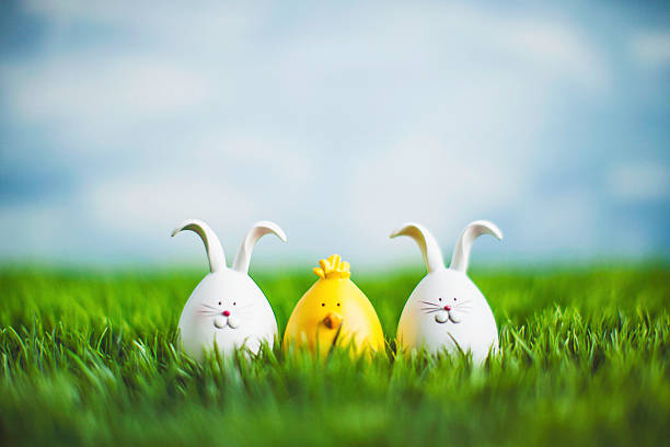 istock Little Easter critters sitting in grass with big blue sky 514837282