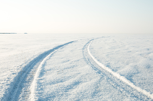 snow desert and the tracks of the car in snow