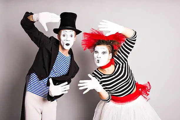 Waist-up portrait of funny mime couple with white faces. April Fools' Day - concept.