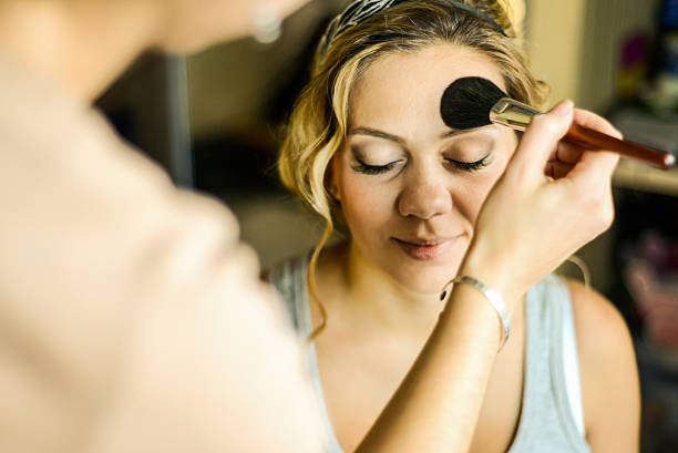 istock Make-up artist applying makeup on model, close up 514839712