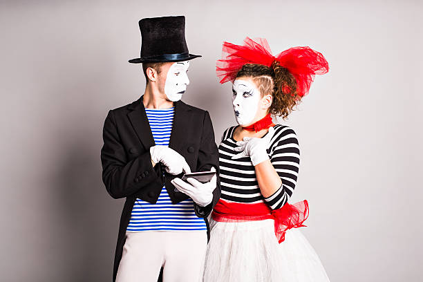 istock two mimes use of tablet,  April Fools Day concept 514840946