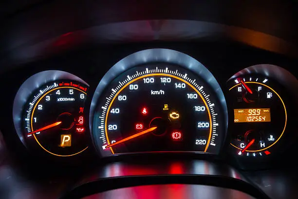 Photo of Modern car instrument dashboard panel in night time