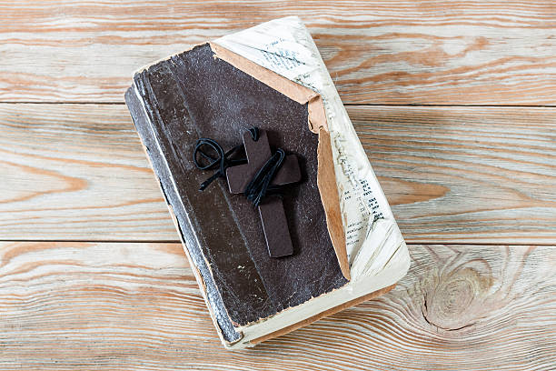 istock Wooden Christian cross on bible. 514843862
