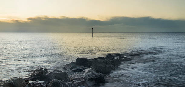 istock Stunning sunrise landscape over rocks in sea 514845254