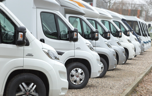 Hamburg, Germany - March 10, 2016: Street shot of a line new Fiat Camper vans. Most of them are white. 