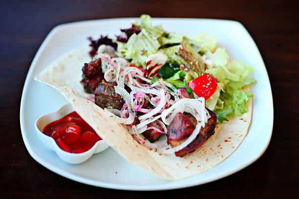 istock salad on a plate with sauce, meat and greens 514852043