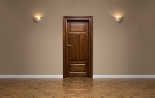 Close up of wooden door in the empty room with copy space