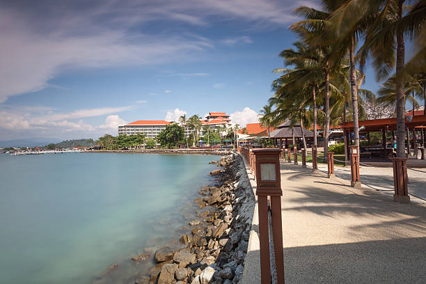 View of nice infinity pool with clear blue water and tropic beach on back