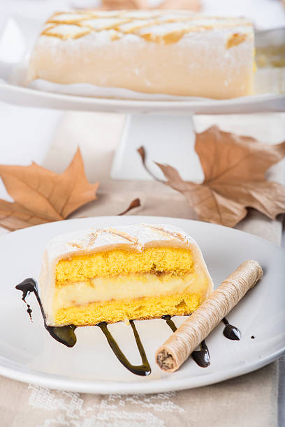 Sweet dessert made of sponge cake marzipan and pastry cream covered with glass burnt sugar