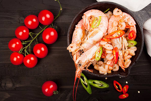 istock shrimp on a wooden background. Top view 514854388