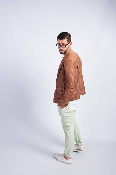 istock Fashionable man in brown jacket standing in the studio 514854982