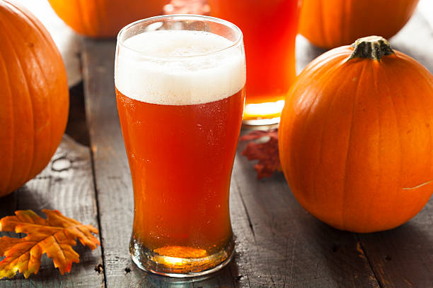 Frothy Orange Pumpkin Ale Frothy Orange Pumpkin Ale Ready to Drink ale stock pictures, royalty-free photos & images