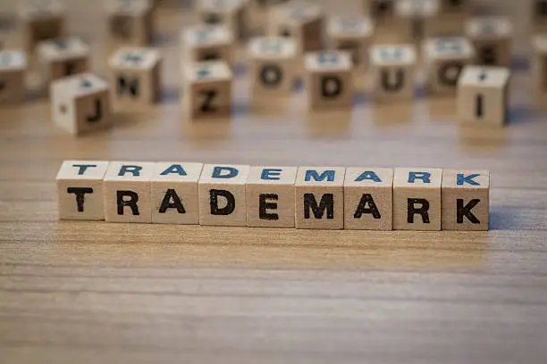 Photo of Trademark written in wooden cubes