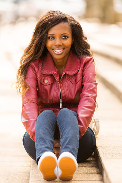 istock african woman sitting outdoors 514856155