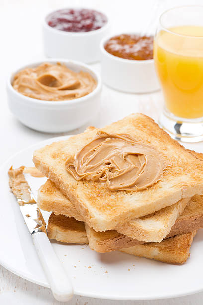 toast with various jams and peanut butter, orange juice