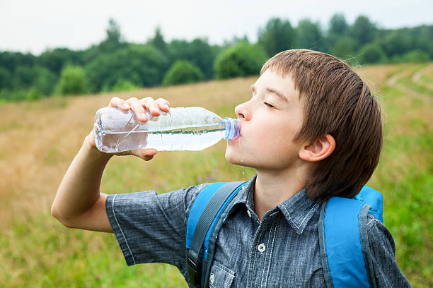 istock Kid drink water oudoors 514859791