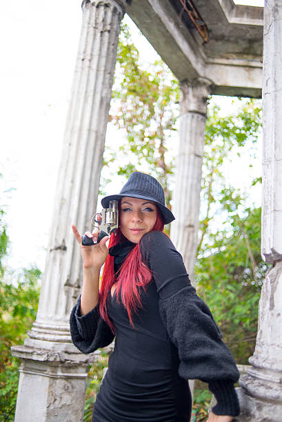 istock Young girl with a pistol in hands 514875209