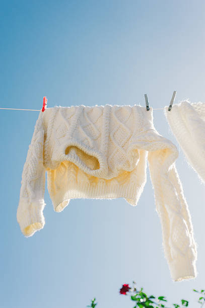 istock Woollen jumpers on washing line a sunny autumn day 514876193
