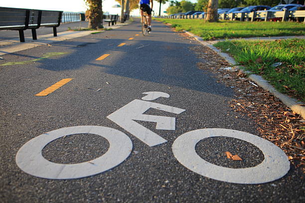 Bicycle lane in the autumn park close to the Verrazano-Narrows Bridge , The largest and longest bridge in New York City