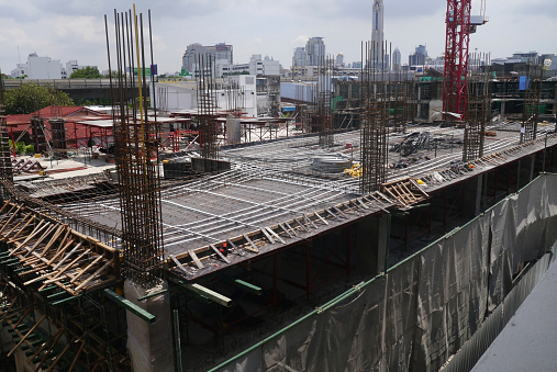 Construction site with crane and building by aerial view