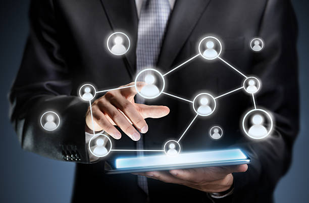 istock Businessman pressing people icons on a tablet 514877801