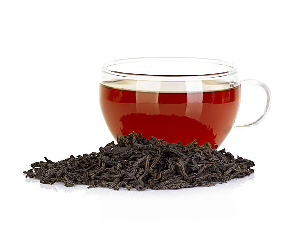 istock Cup of tea and leaves black tea isolated on white 514880033