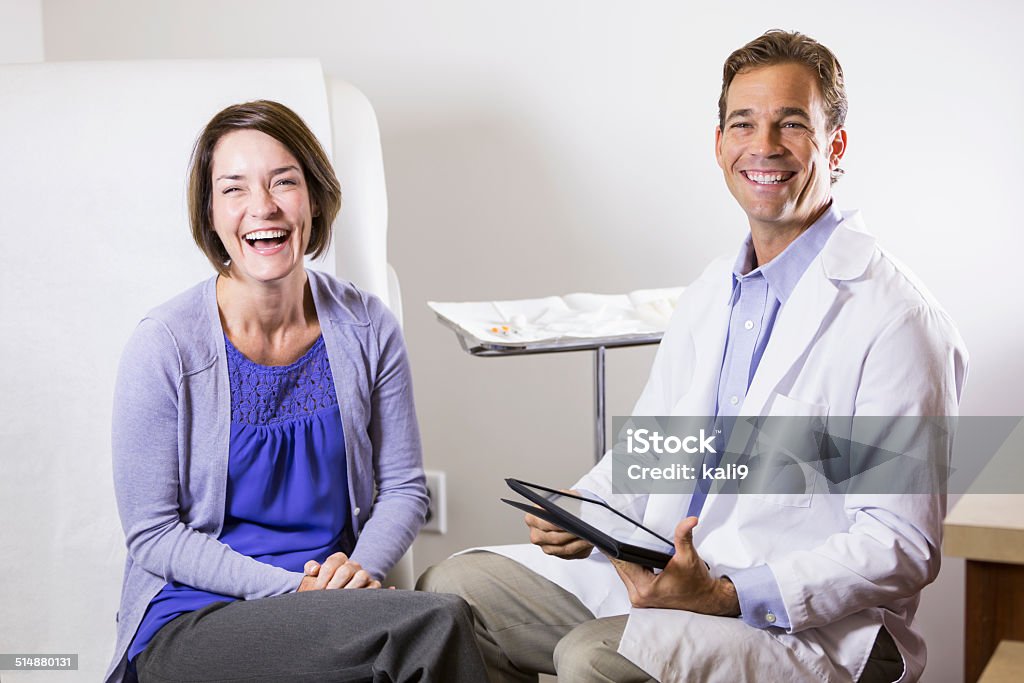 Doctor and patient Mature woman (40s) in doctor's office. Doctor's Office Stock Photo