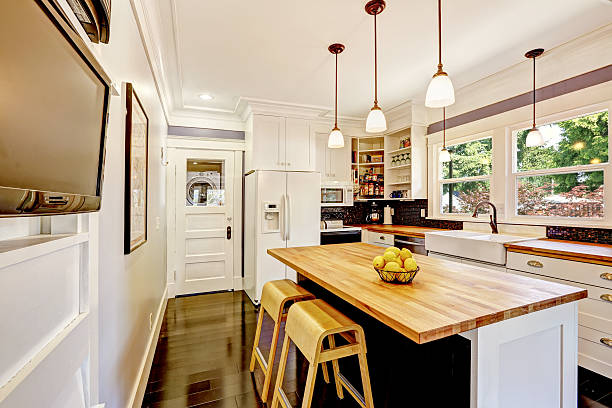 istock White kitchen with wooden counter top island 514880563
