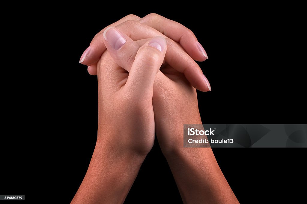 Two hands praying Two hands  isolated on a black background, praying Adult Stock Photo
