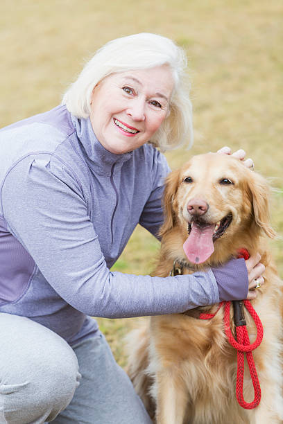 istock Senior woman with golden retriever 514880647