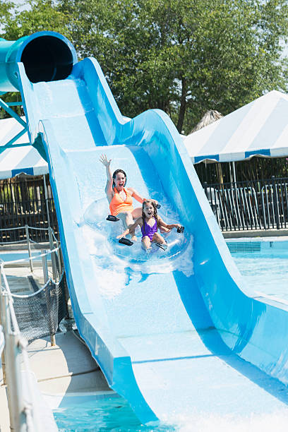 istock Mother and daughter on water slide 514880695