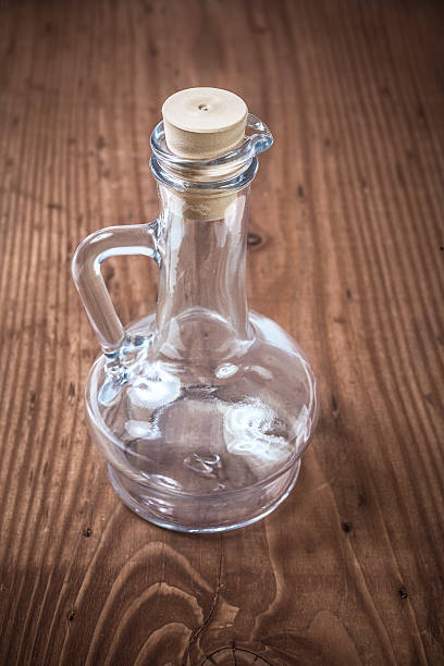 istock Empty kitchen bottle for oil on old wooden board 514880715