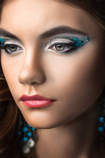 istock brunette girl with long hair and creative makeup 514881159