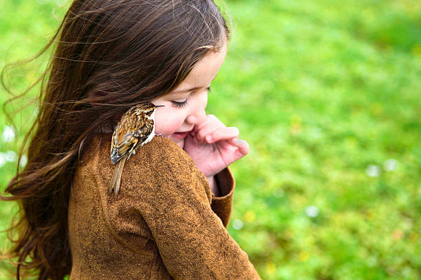 istock Little girl making friend with a bird 514881779