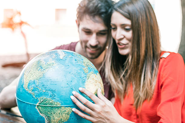 Young Smiling Couple with a Globe stock photo