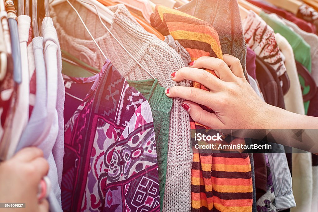 looking on a flea market for clothes close up of a hand, looking on a flea market for clothes. Thrift Store Stock Photo