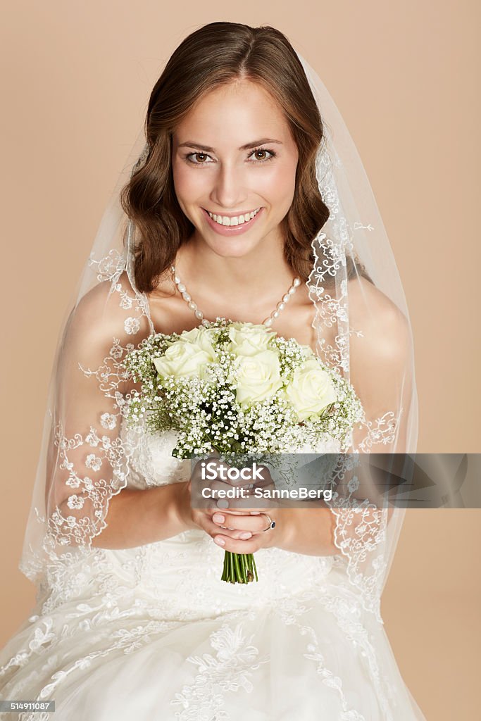 Stunning young bride holding bouquet, portrait 20-24 Years Stock Photo