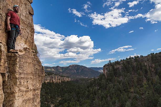 Rock Climber Look Out From Rock Face