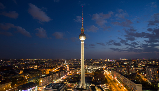 Panoramic shot of Berlin at dusk. City streets and famous Television Tower at Alexanderplatz illuminated. - Germany