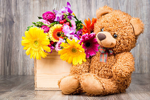 istock Bunch of flowers and a teddy bear 514915094