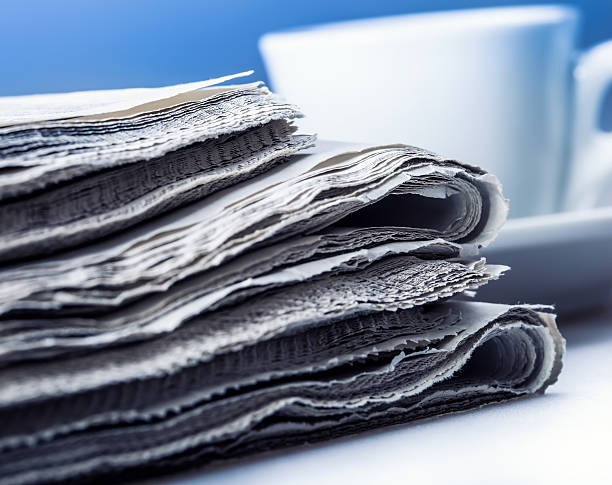 istock Newspaper on a table with a cup of coffee. 514915907