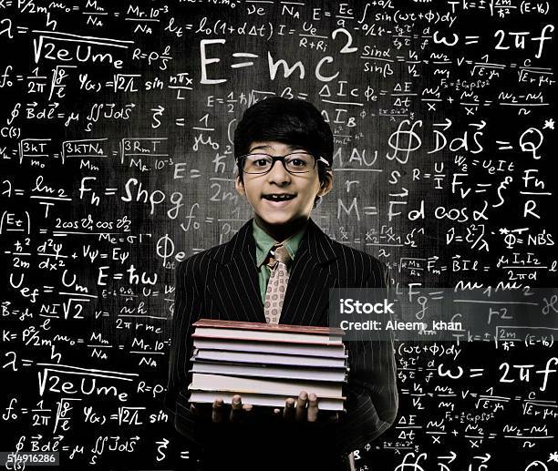 Genius Little Boy Holding Book Wearing Glasses Chalkboard Stock Photo - Download Image Now