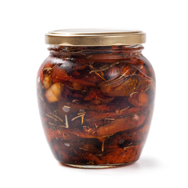 istock Sun-dried tomatoes in the pot isolated on white background 514916449