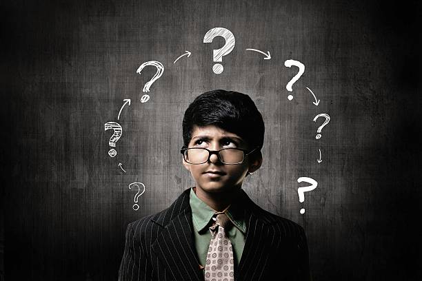 istock Confuse Little Boy Wearing Glasses, Thinking Near Chalkboard 514916624