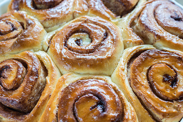 istock Cinnamon rolls on the wooden background 514916796