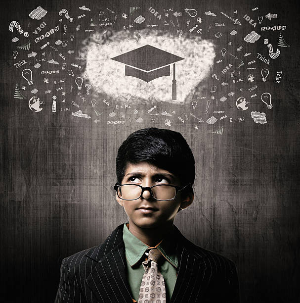 Genius Little Boy Wearing Glasses, Thinking Gradution Cap stock photo